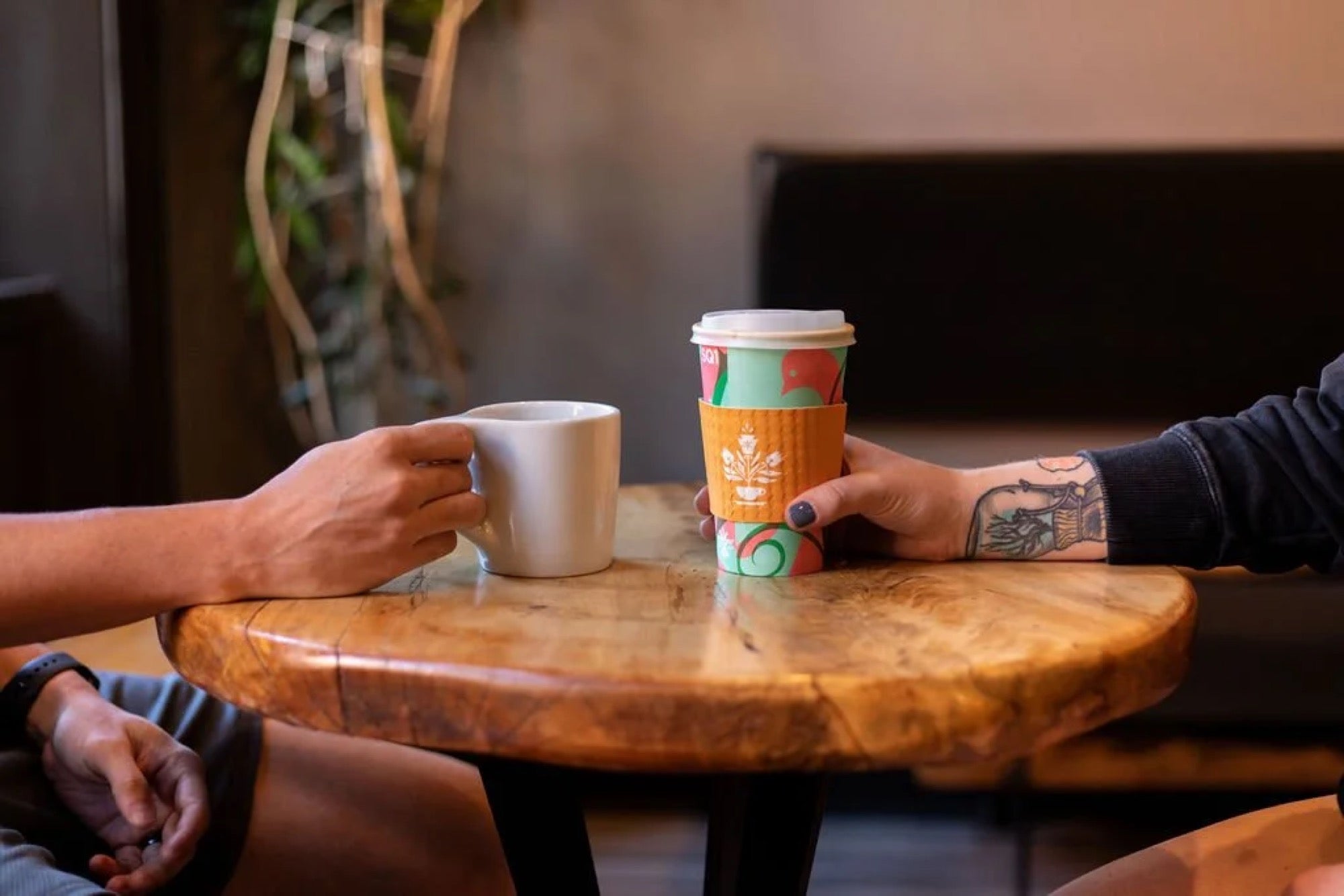 Two friends sharing coffee at a cafe table