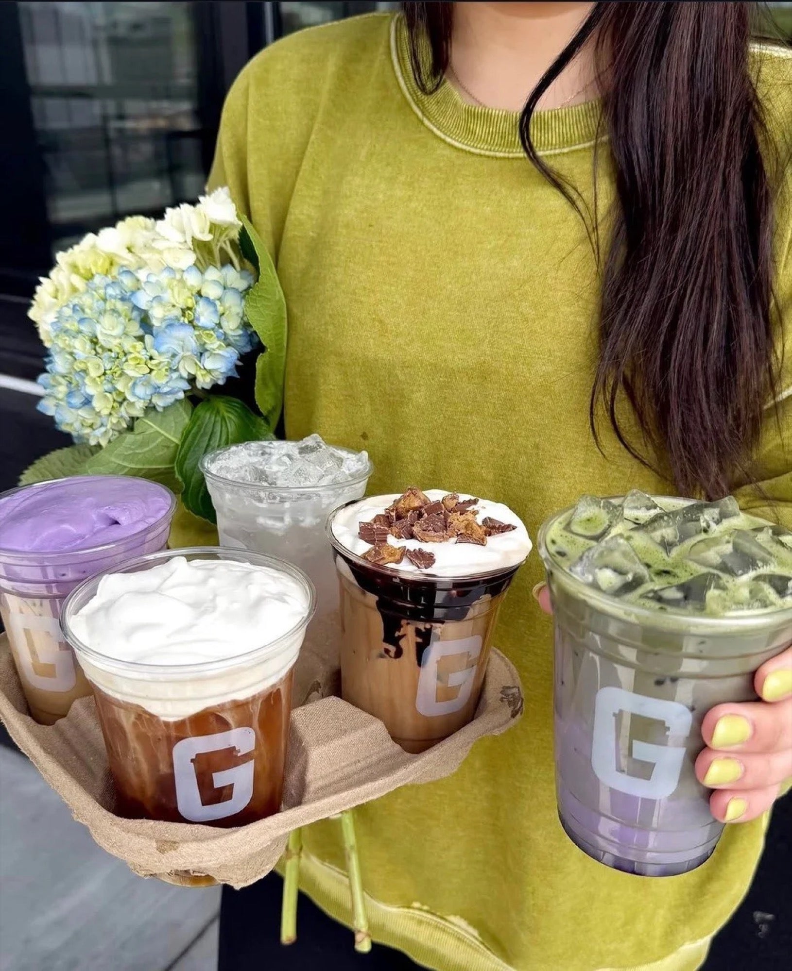 A customer carrying a flight of Square One drinks