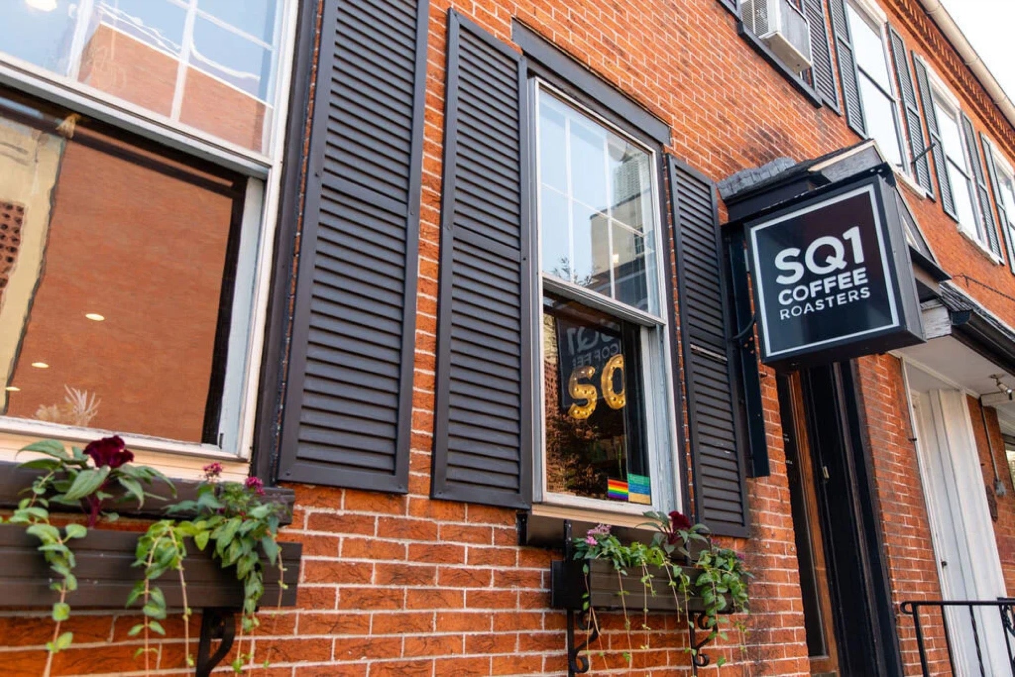 The SQ1 Coffee Roasters storefront sign on brick