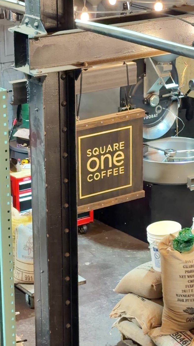 The Square One Coffee sign hanging in the Lancaster roastery